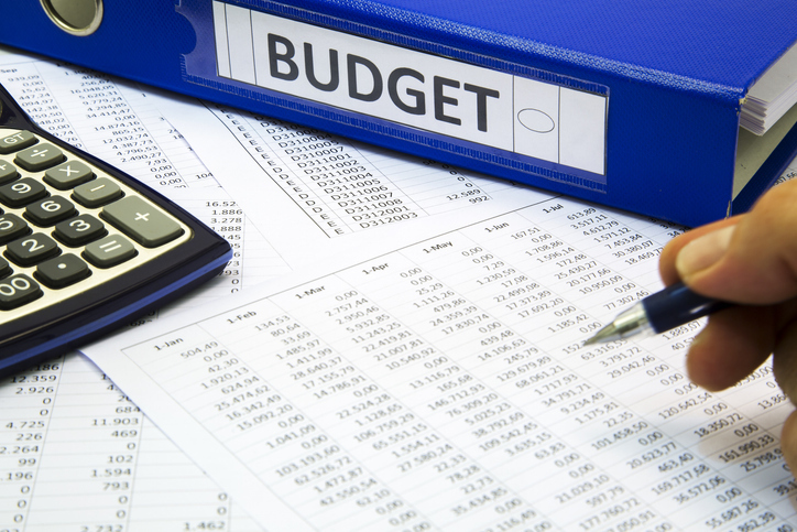 Reviewing spreadsheets and budget plans for facility maintenance costs