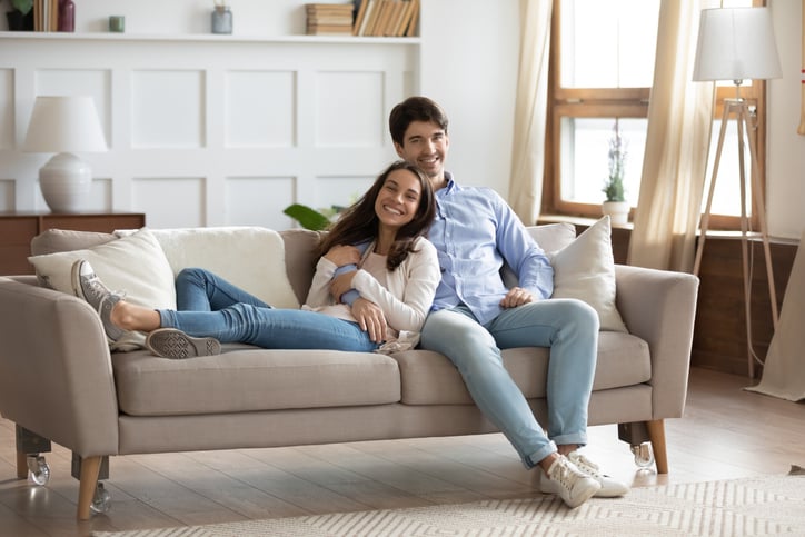 happy tenants sitting on couch