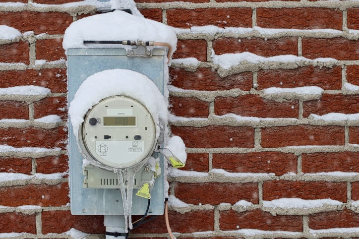 residential water meter covered in snow